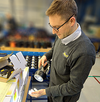 Toby Hudson, Wolfs Quality Assurance Manager, checking an XT Handlamp prior to despatch